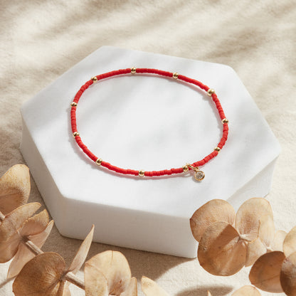 PULSERA ROJA ELASTICADA GOLDFILLED CON PUNTO DE LUZ