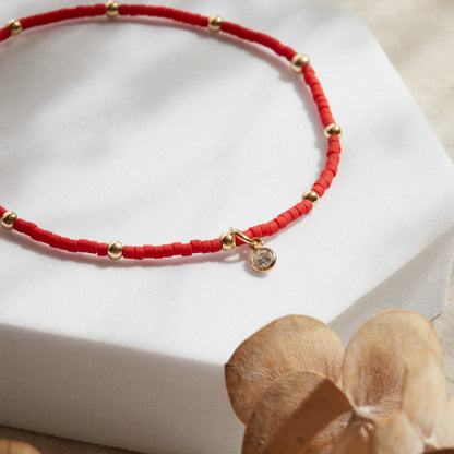 PULSERA ROJA ELASTICADA GOLDFILLED CON PUNTO DE LUZ