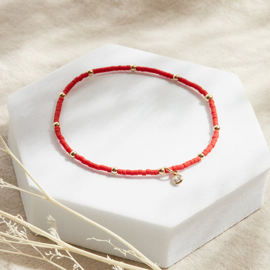 PULSERA ROJA ELASTICADA GOLDFILLED CON PUNTO DE LUZ