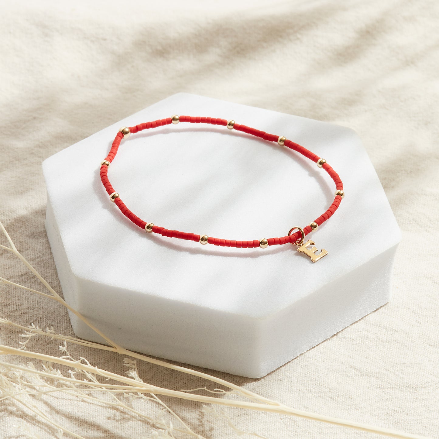 PULSERA ROJA ELASTICADA GOLDFILLED CON INICIAL