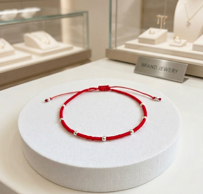 PULSERA ROJA AJUSTABLE SIETE