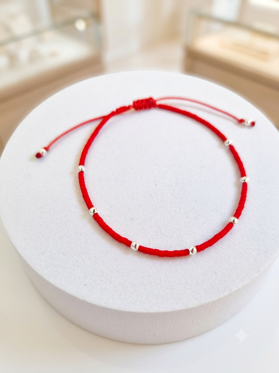 PULSERA ROJA AJUSTABLE SIETE